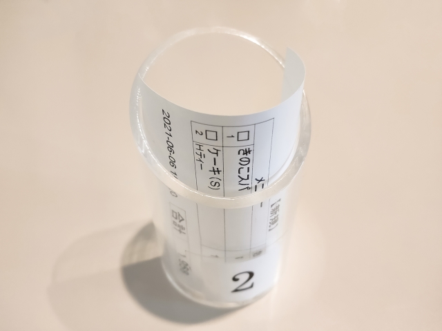 Plastic bill holder used in a Japanese family restaurant payment system