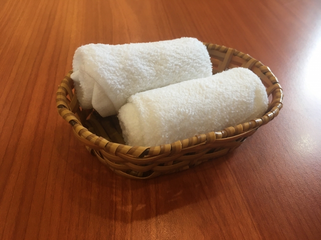 Cloth oshibori towels in a basket at a Japanese restaurant