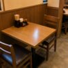 A compact two-person table in a Japanese restaurant, showing the simple and space-efficient design common in everyday dining