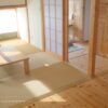 A modern washitsu in a Japanese home featuring tatami flooring, shoji screens, sliding doors, and soft natural light creating a calm and flexible living space