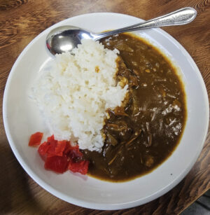 Japanese curry rice served with a small portion of red fukujinzuke pickles.
