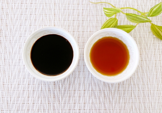 Two bowls of soy sauce showing a clear difference in color and appearance.