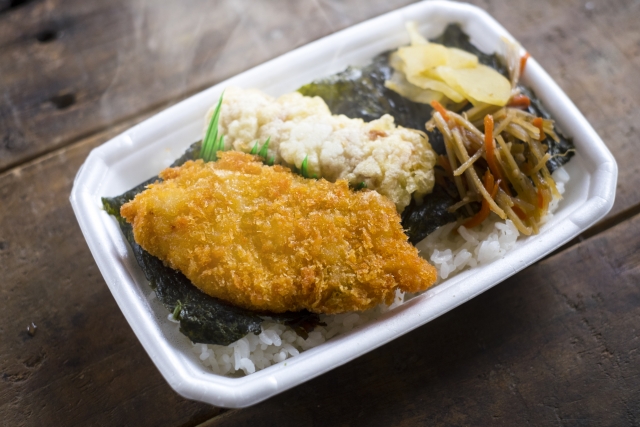 A simple noriben lunch box with nori laid over rice and topped with everyday fried and side dishes, showing a common non-sushi use of nori in Japan.