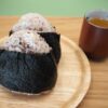 Simple Japanese onigiri served with green tea, showing onigiri as an ordinary part of Japanese food culture.