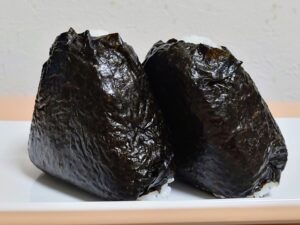 Homemade onigiri wrapped in softened nori that has absorbed moisture from the rice.