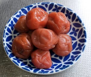 A bowl of salty and sour umeboshi, a strongly flavored preserved ume fruit eaten with rice.