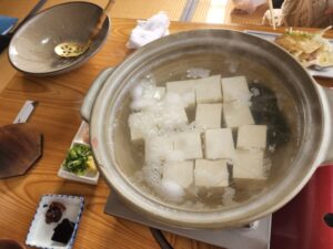 Yudofu, tofu gently warmed in a pot of hot water, served with condiments..