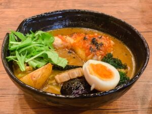 Japanese soup curry with chicken, egg, and large pieces of vegetables