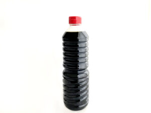 A large bottle of soy sauce commonly used for everyday cooking in the kitchen.