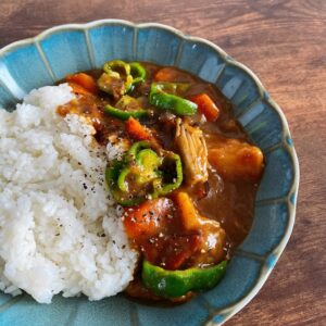 Japanese summer vegetable curry with rice, peppers, carrots, mushrooms, and chicken