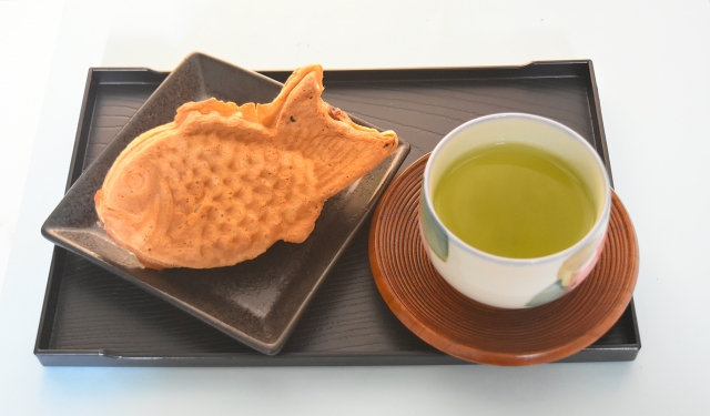 Taiyaki filled with sweet red bean paste served with a cup of sencha green tea.