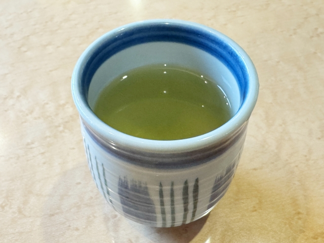 A cup of strong Japanese green tea brewed from fine konacha particles