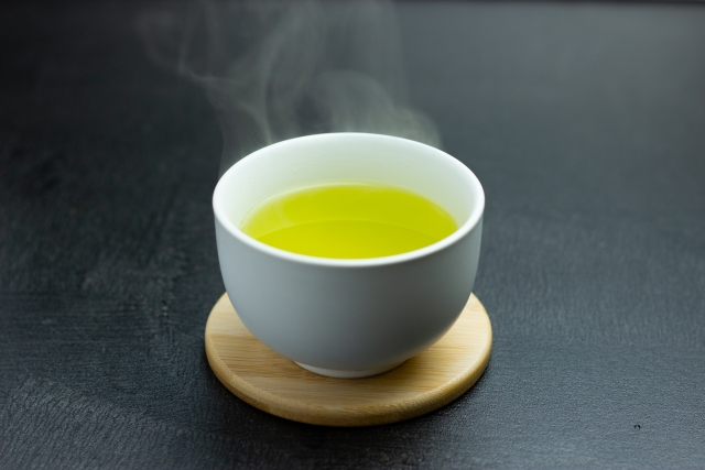 A hot cup of Japanese green tea with rising steam