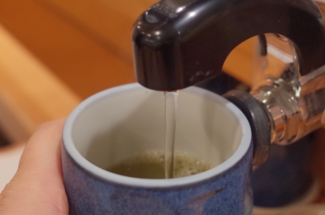 Hot water being poured into a teacup at a Japanese sushi restaurant