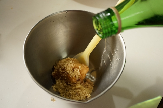 Japanese sake being added to food during cooking