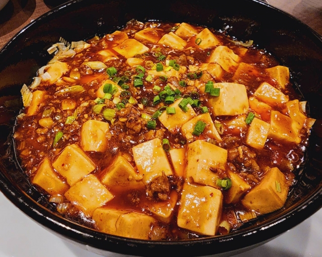 Mapo tofu served in a pan, representing a dish sometimes finished with a little vinegar at the end.