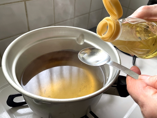 Mirin being added to a pot during Japanese home cooking