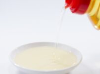 Golden mirin being poured into a small white dish