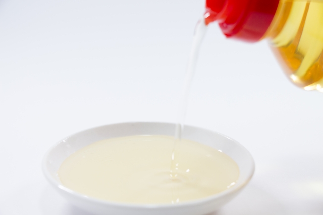 Golden mirin being poured into a small white dish