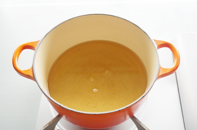 Mirin being heated in a pot to reduce its alcohol before cooking