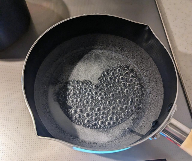 Sake being heated to cook off the alcohol